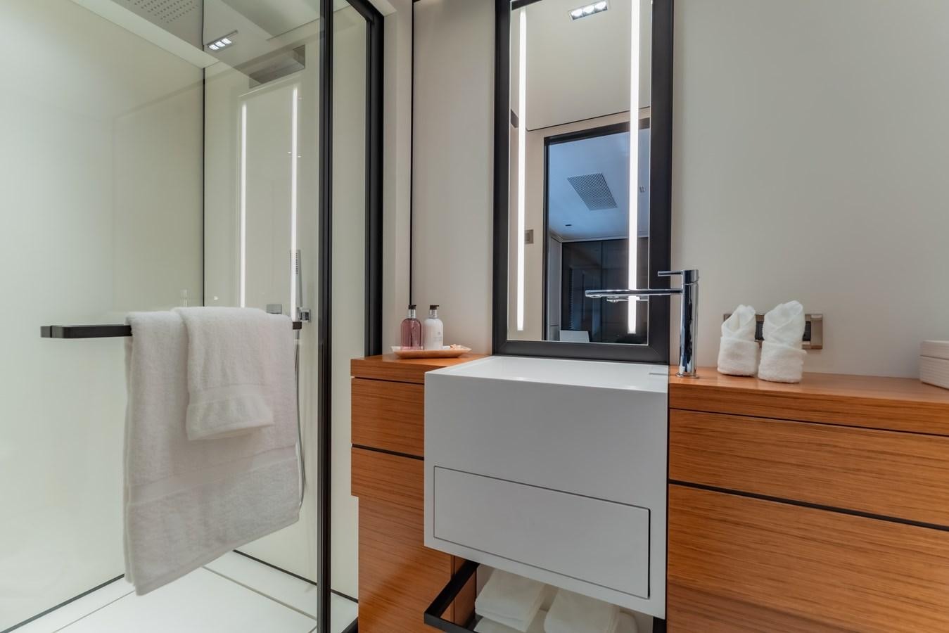 a bathroom with a sink and mirror aboard SPACECAT Yacht for Sale