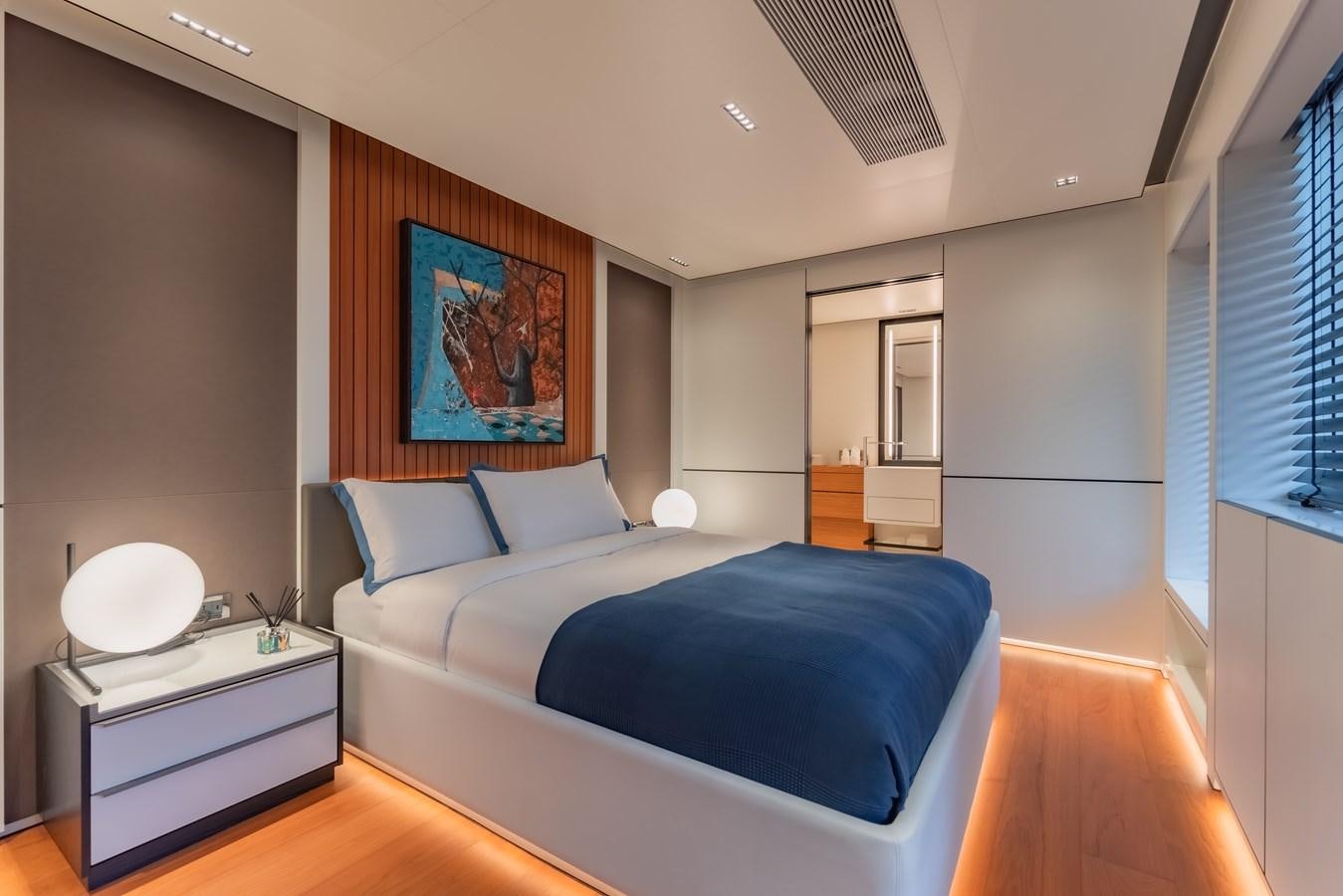 a bedroom with a bed and a desk aboard SPACECAT Yacht for Sale