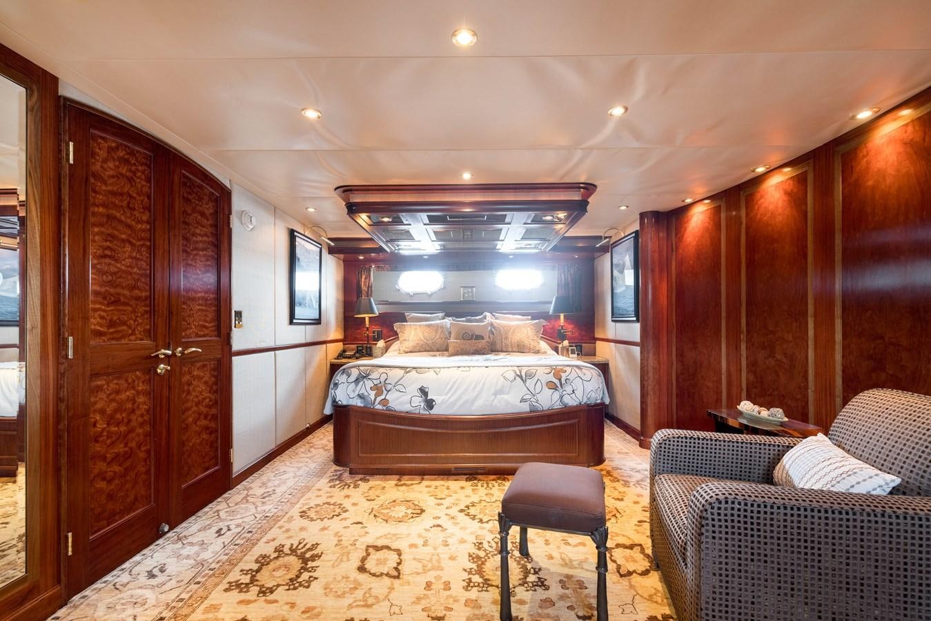 a bedroom with a bed and a couch aboard REPOSADO Yacht for Sale