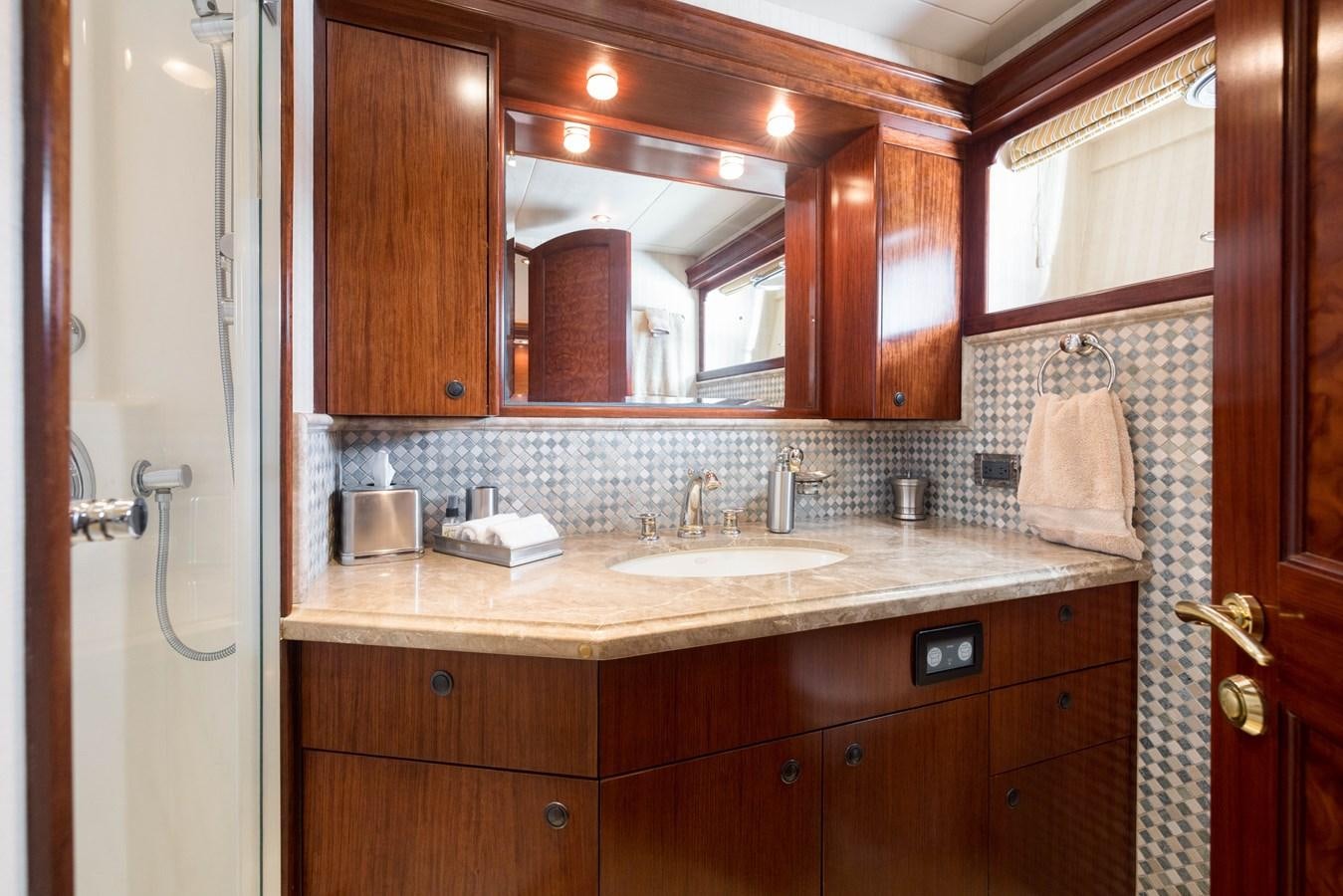 a bathroom with a sink and mirror aboard REPOSADO Yacht for Sale