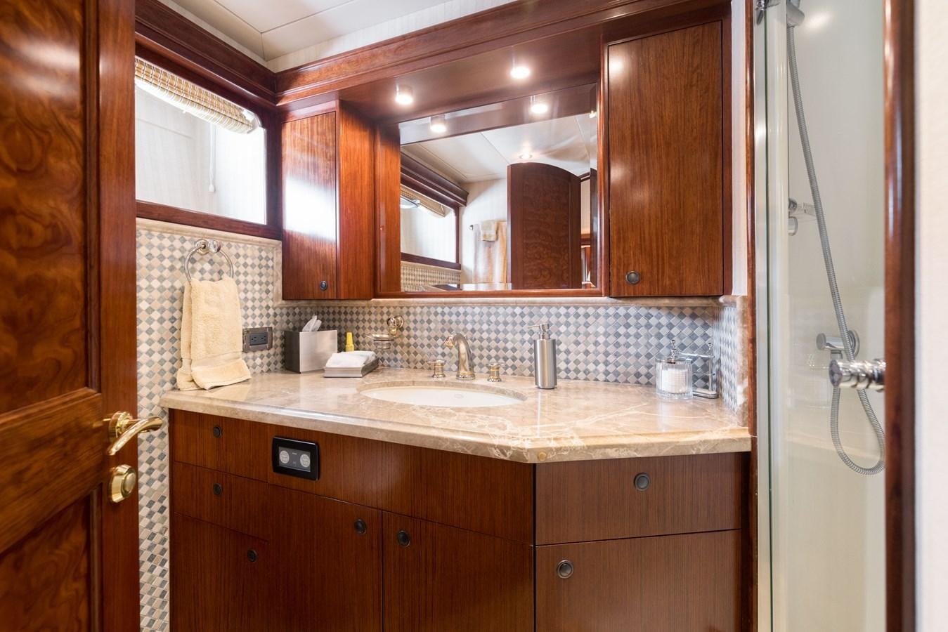 a bathroom with wooden cabinets aboard REPOSADO Yacht for Sale