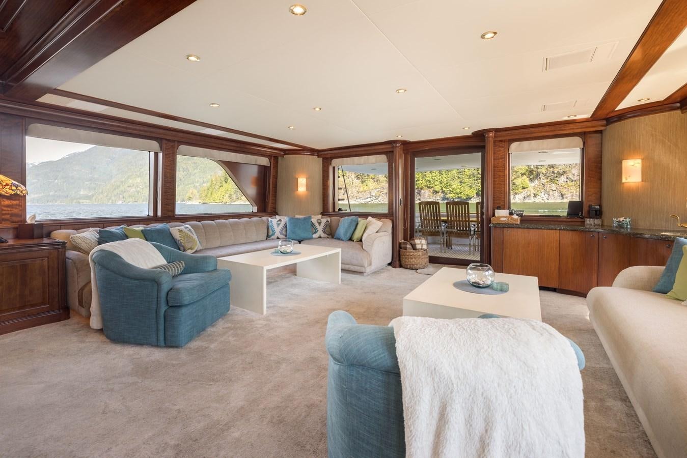 a living room with a large window aboard REPOSADO Yacht for Sale