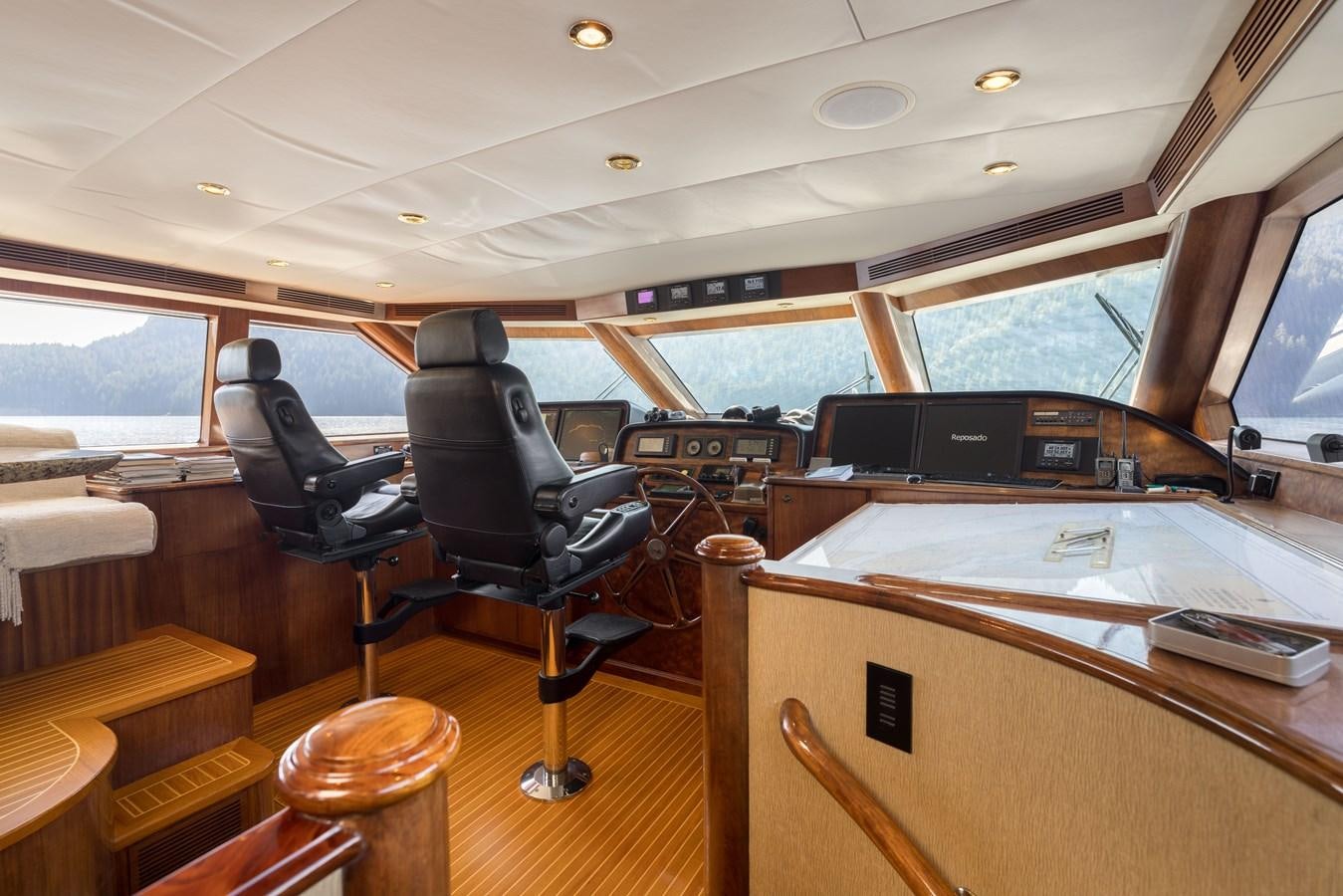 inside of a vehicle with a desk and a chair aboard REPOSADO Yacht for Sale