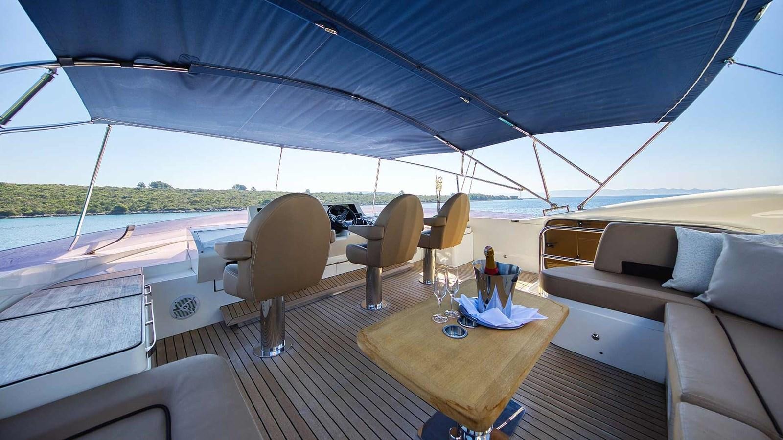 a boat with a table and chairs aboard AGAVE Yacht for Sale