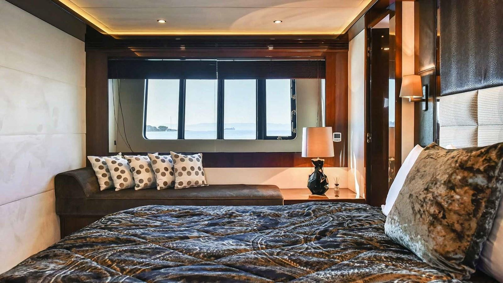a bed with pillows and a window aboard AGAVE Yacht for Sale