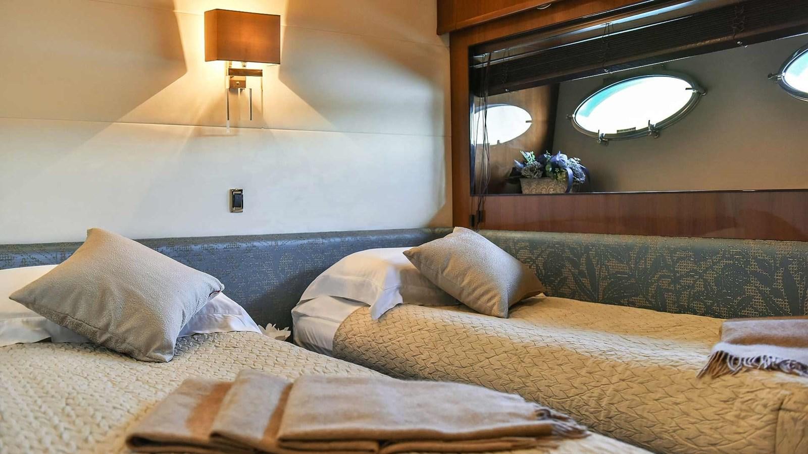 a bed with a bed and a lamp on the wall aboard AGAVE Yacht for Sale