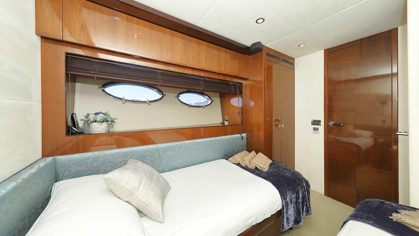 a room with a bed and a mirror aboard AGAVE Yacht for Sale