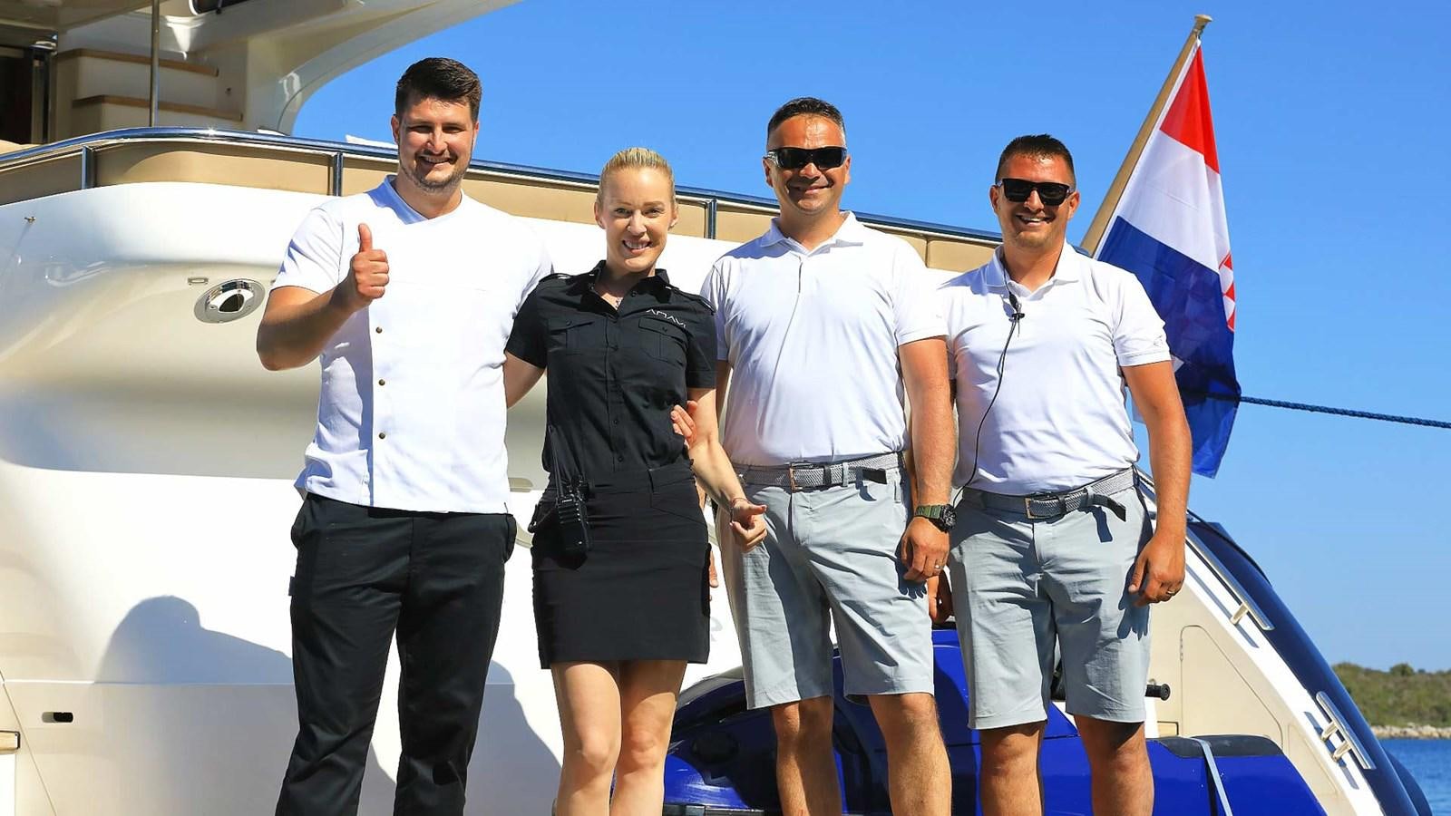 a group of men posing for a photo aboard AGAVE Yacht for Sale