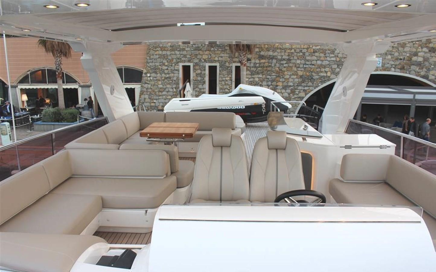 a room with couches and a table and chairs aboard XM Yacht for Sale