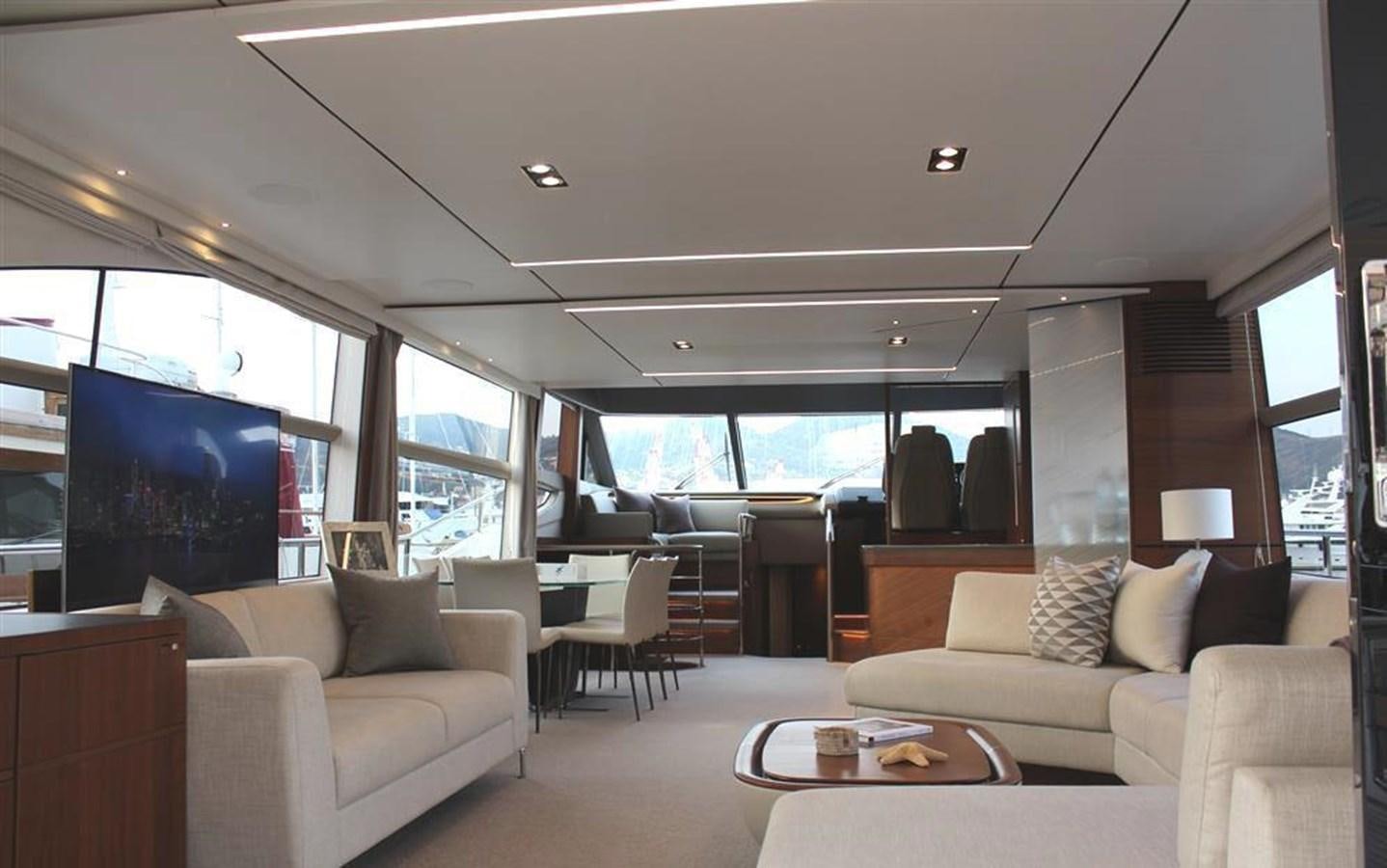 a living room with a couch and a table aboard XM Yacht for Sale