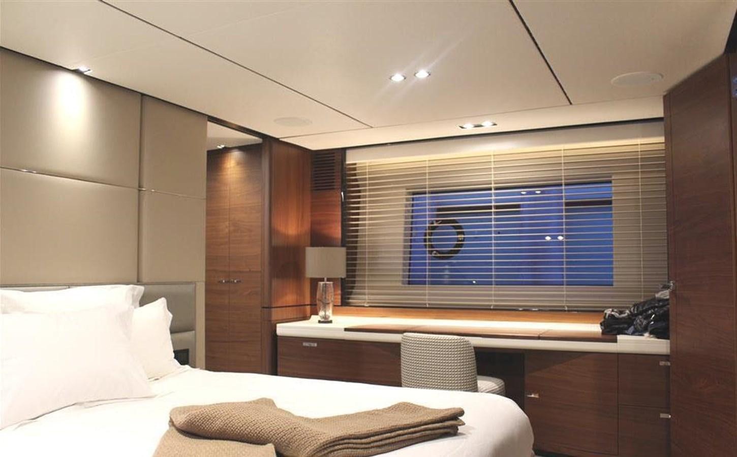 a room with a bed and a window aboard XM Yacht for Sale