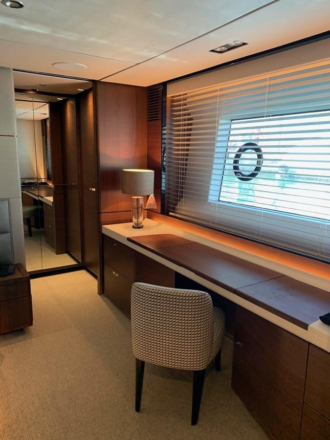 a room with a desk and a window aboard XM Yacht for Sale
