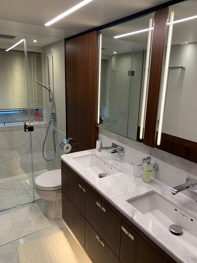 a bathroom with a glass shower aboard XM Yacht for Sale