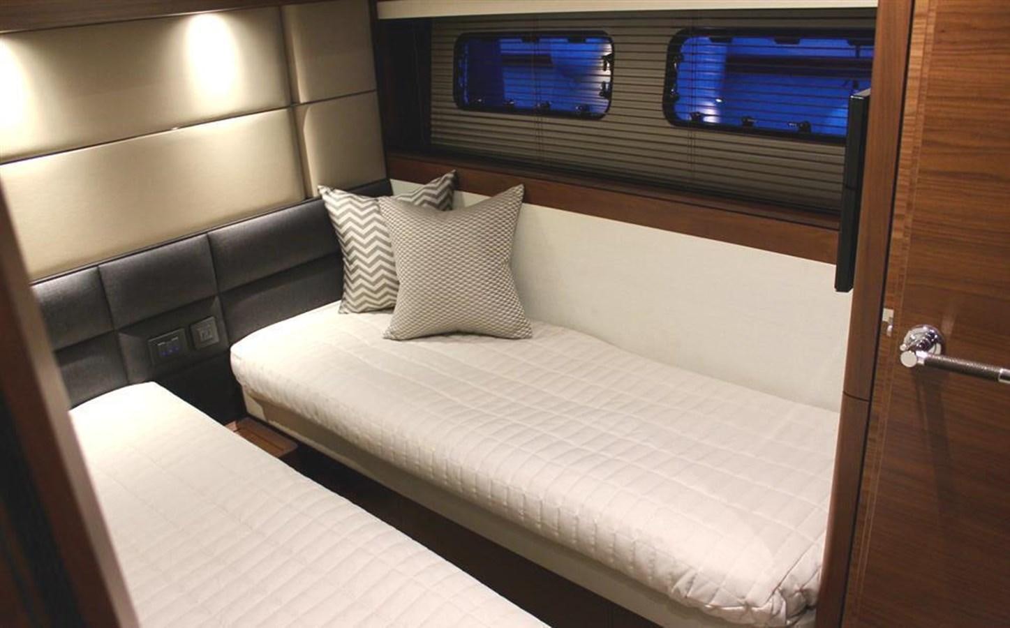a bed in a room aboard XM Yacht for Sale