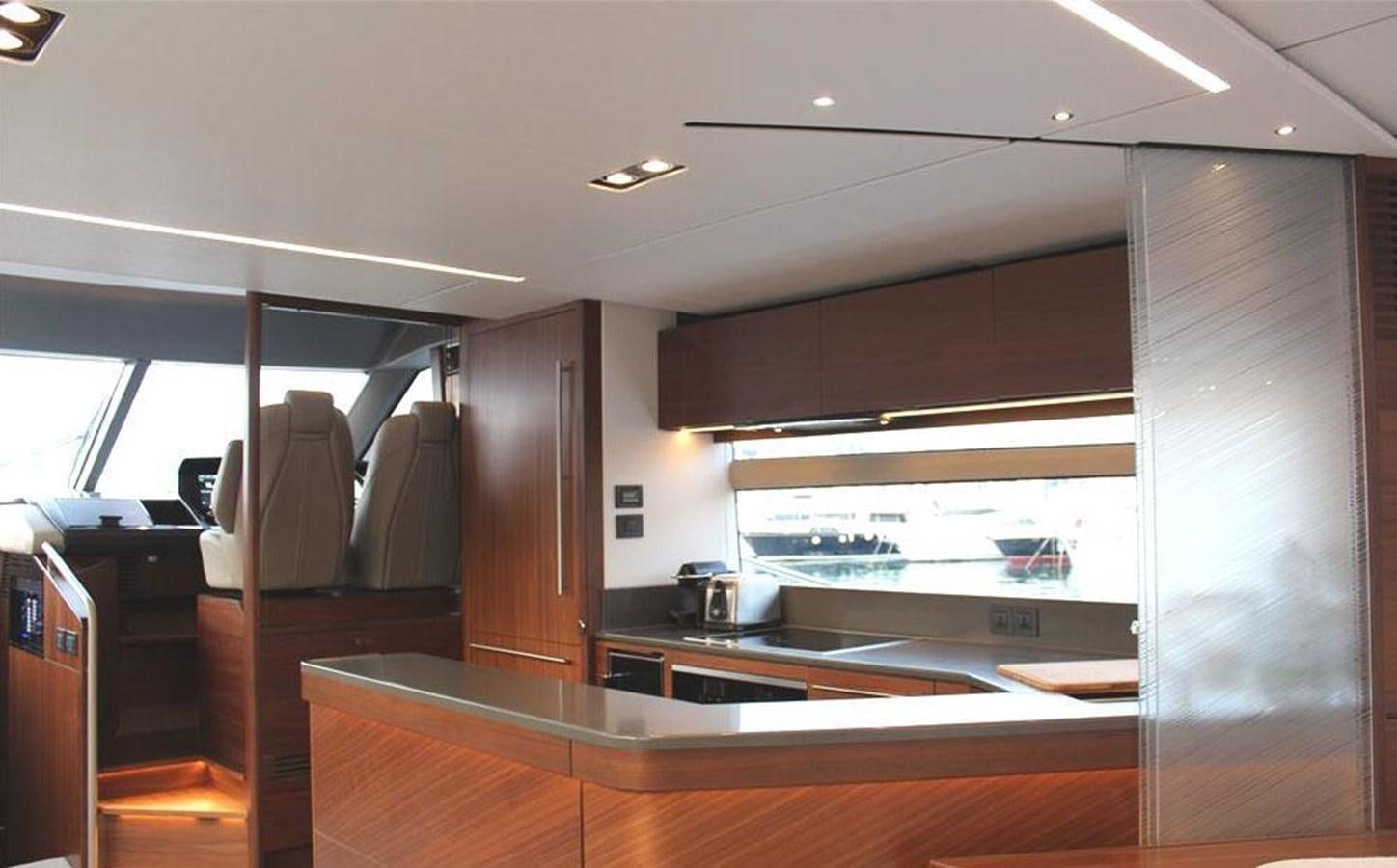 a room with a large window and a table with chairs aboard XM Yacht for Sale