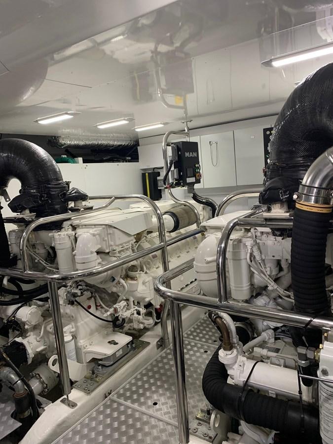 a person working on a machine aboard XM Yacht for Sale