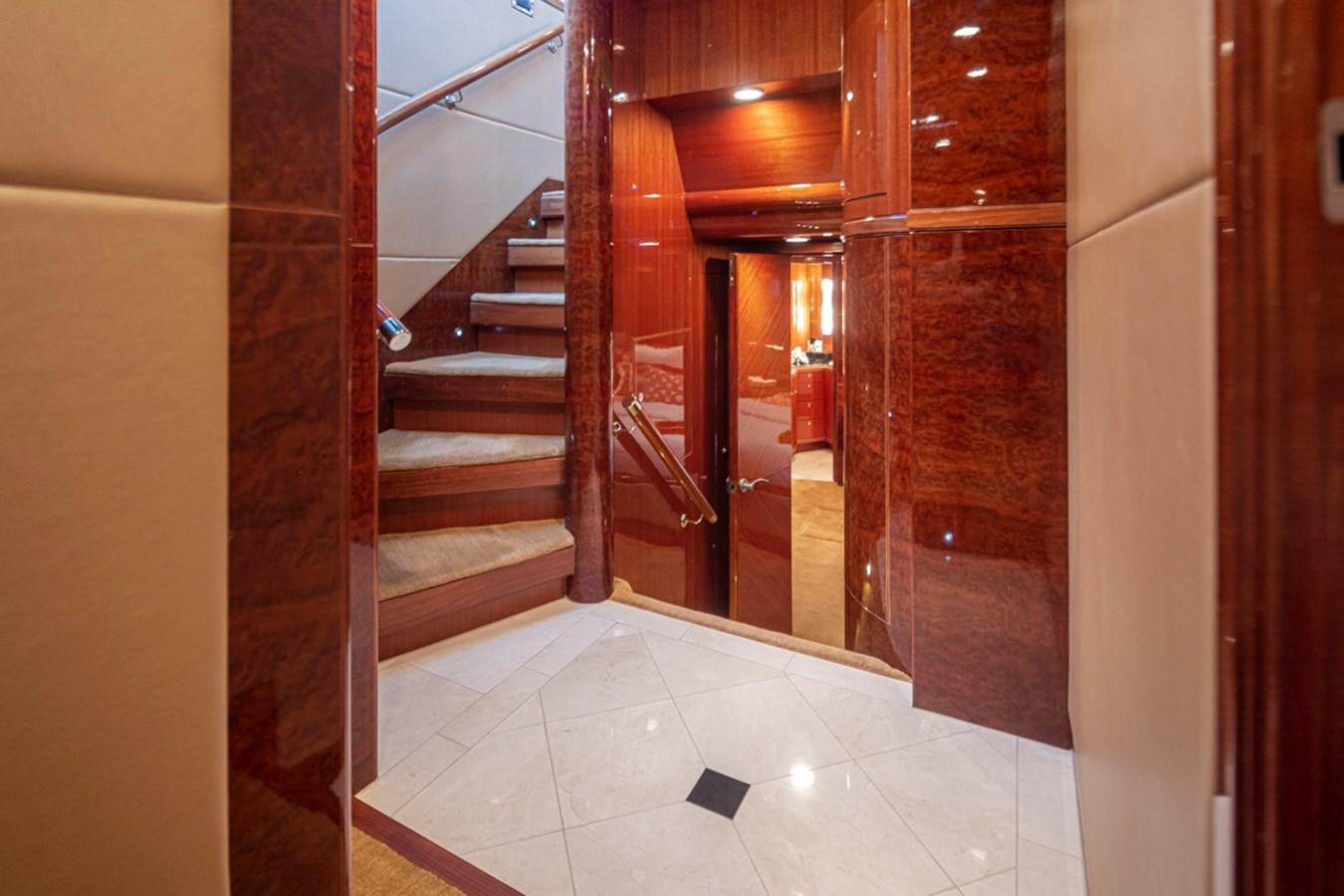 a hallway with a door and a staircase aboard COCONUT Yacht for Sale