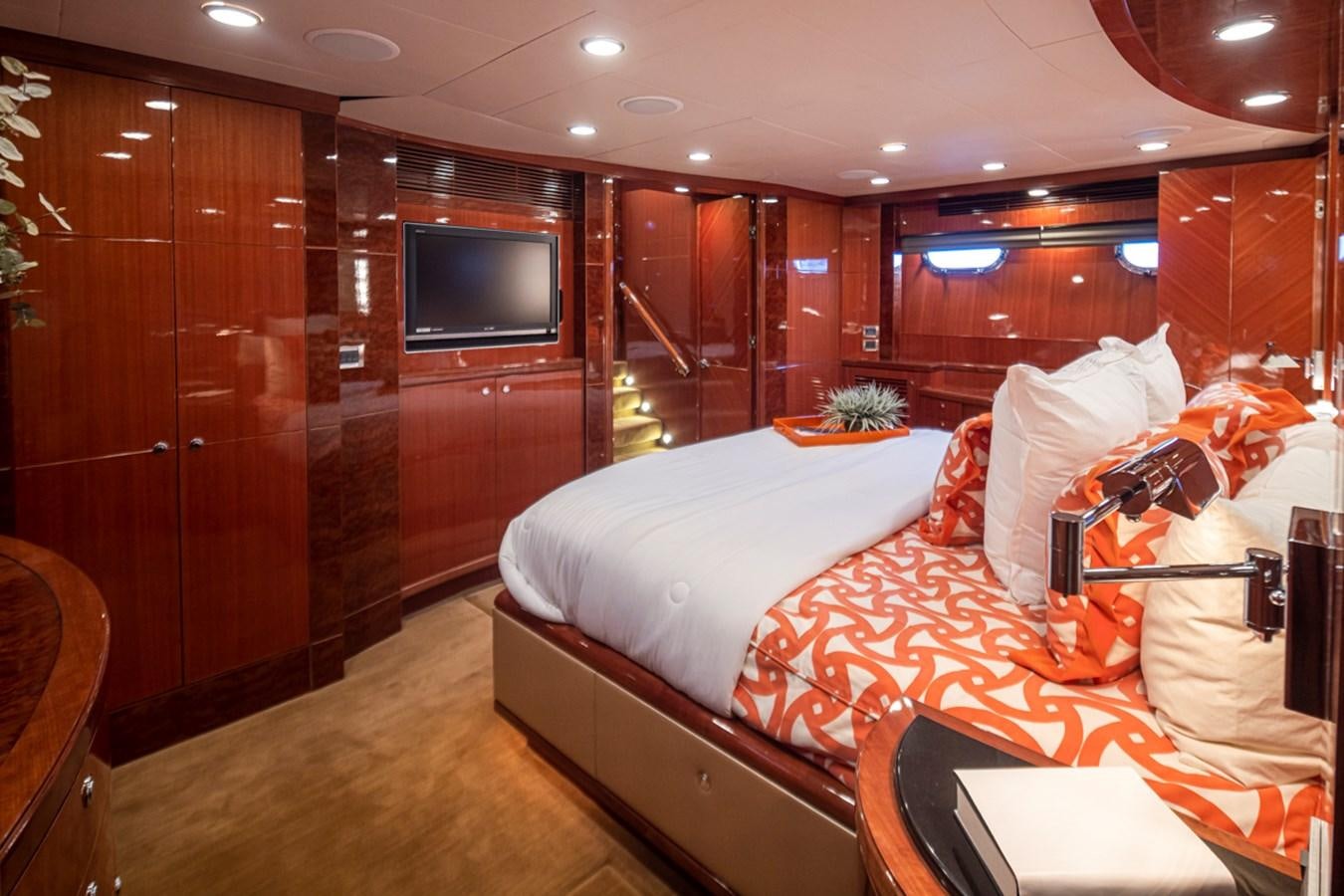 a bedroom with a bed and a television aboard COCONUT Yacht for Sale