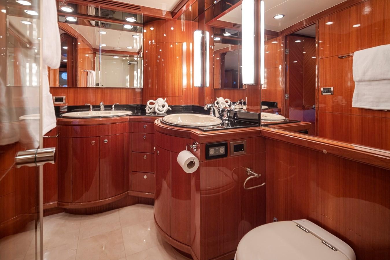 a bathroom with wooden cabinets aboard COCONUT Yacht for Sale