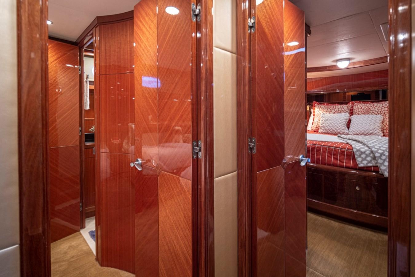 a room with a bed and a closet aboard COCONUT Yacht for Sale