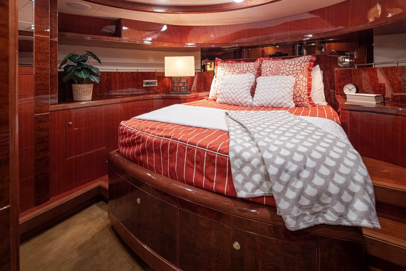 a bed with red and white sheets aboard COCONUT Yacht for Sale