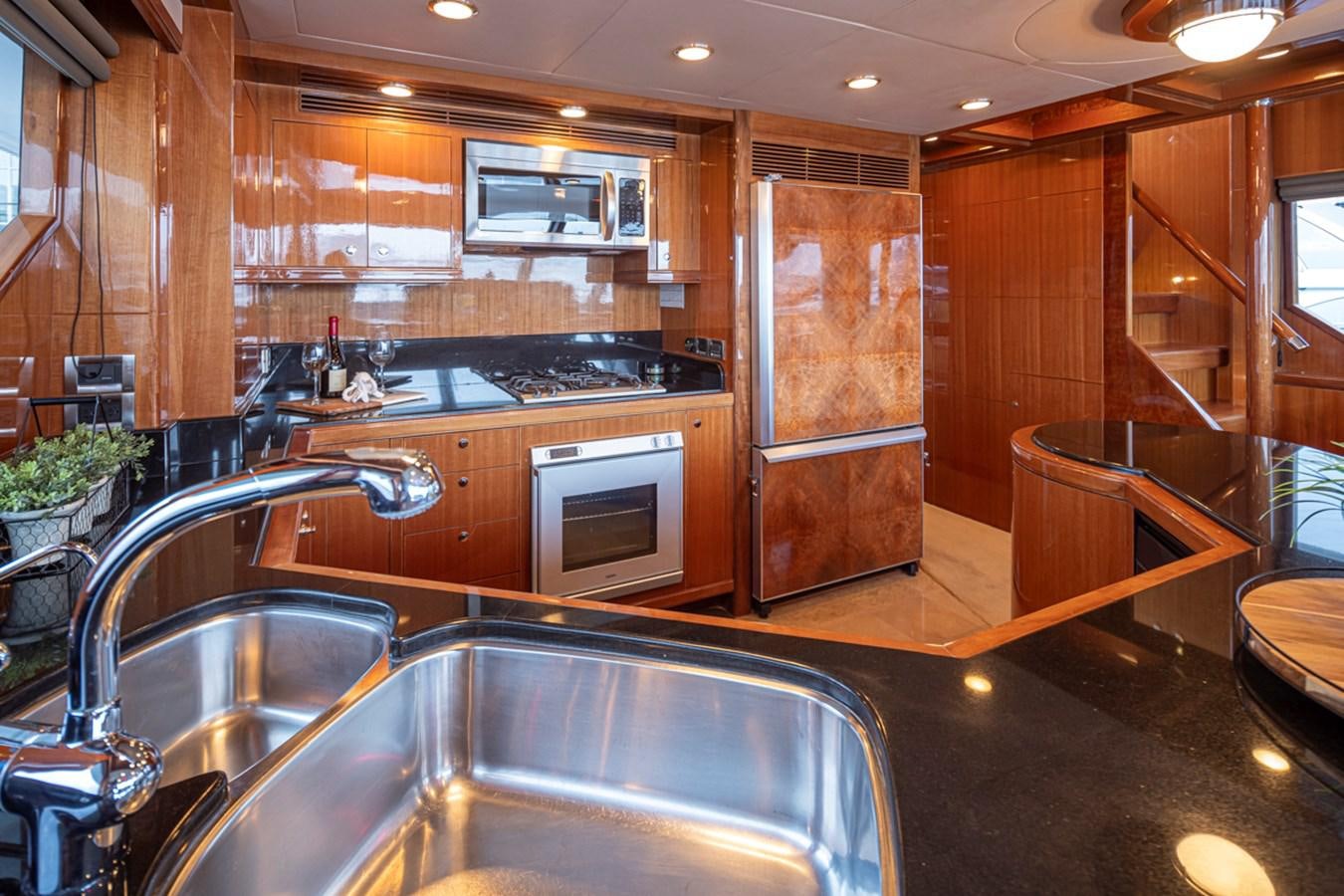 a kitchen with wooden cabinets aboard COCONUT Yacht for Sale