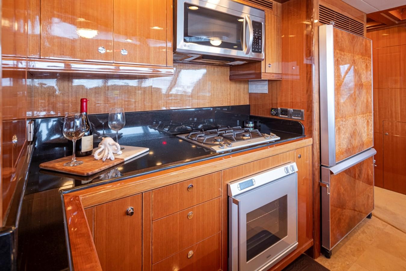 a kitchen with wooden cabinets aboard COCONUT Yacht for Sale