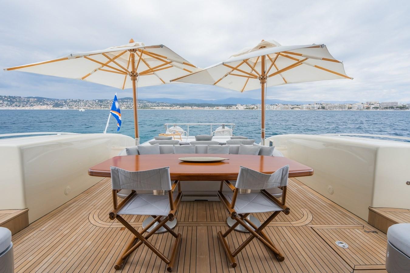 a table and chairs on a deck aboard TECHNOMARINE Yacht for Sale