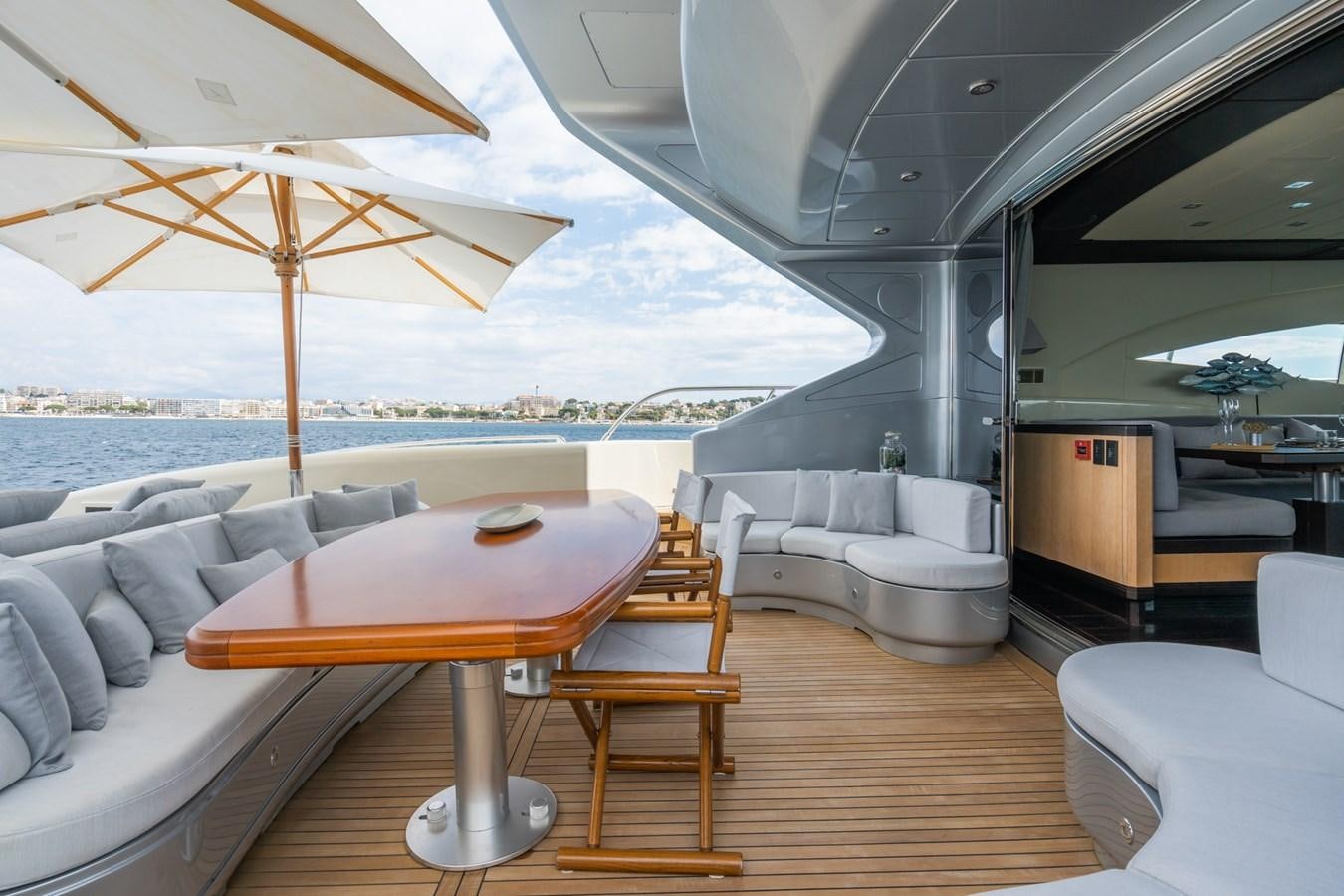 a room with a couch and a table and chairs aboard TECHNOMARINE Yacht for Sale