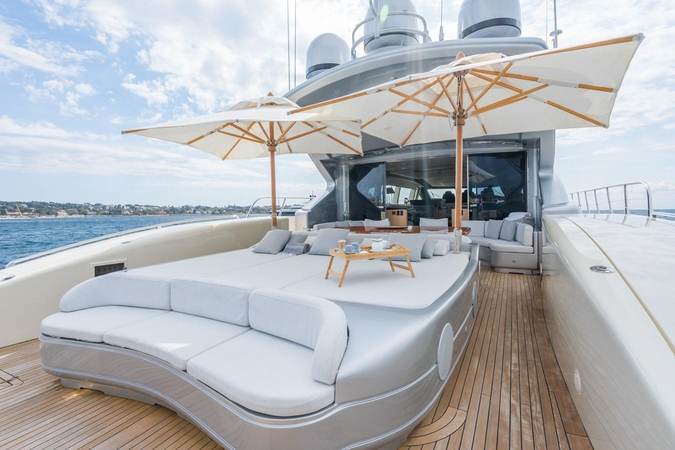 a lounge area with a large umbrella aboard TECHNOMARINE Yacht for Sale
