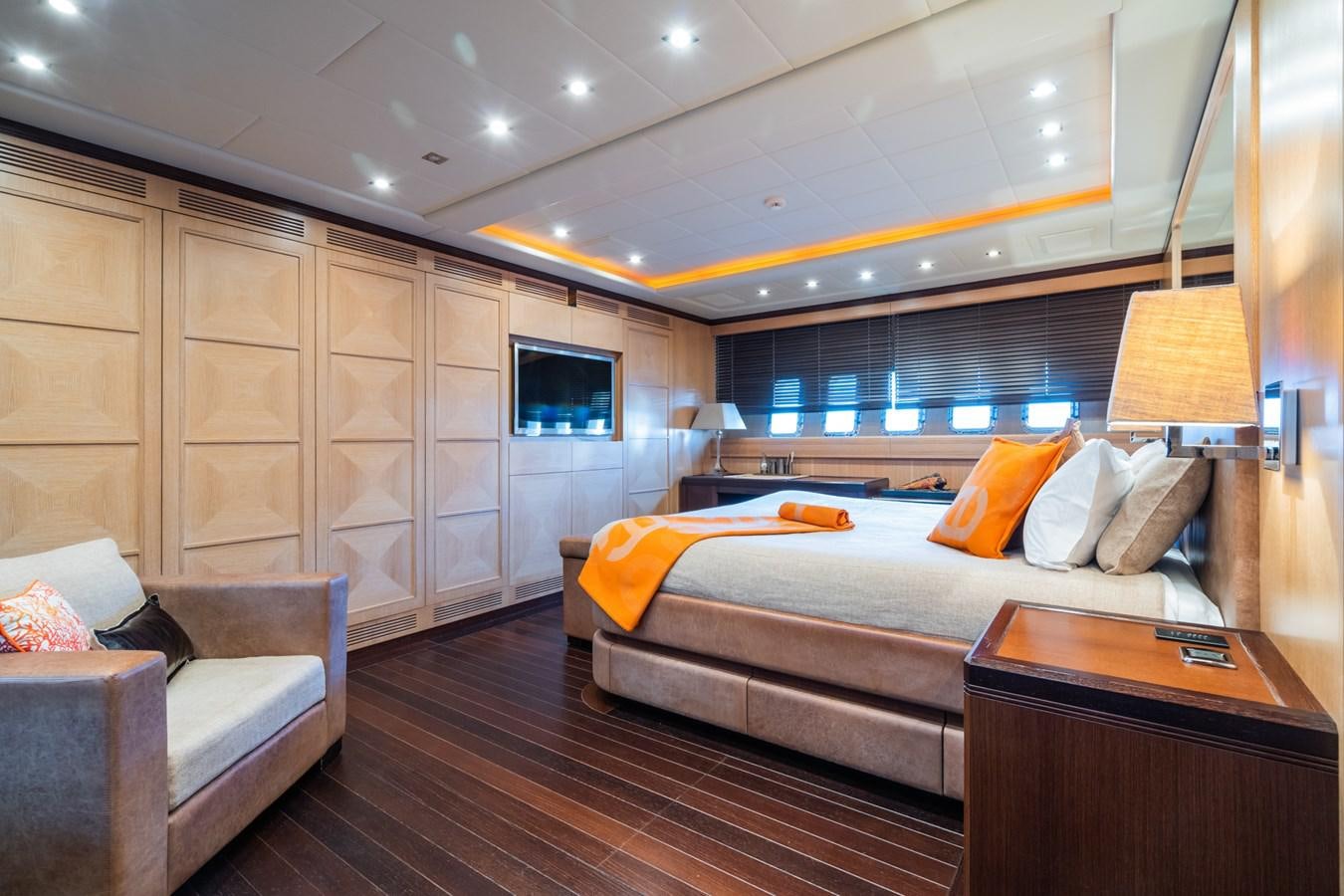 a room with a bed and a couch aboard TECHNOMARINE Yacht for Sale