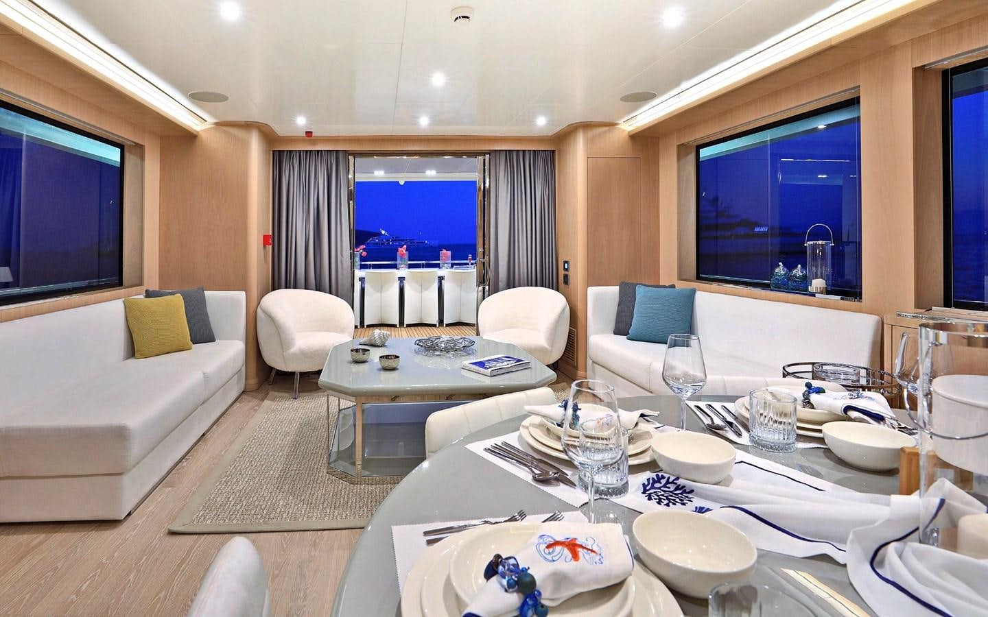 a large room with a table and chairs aboard AEGEAN EXPLORER 26M/02 Yacht for Sale