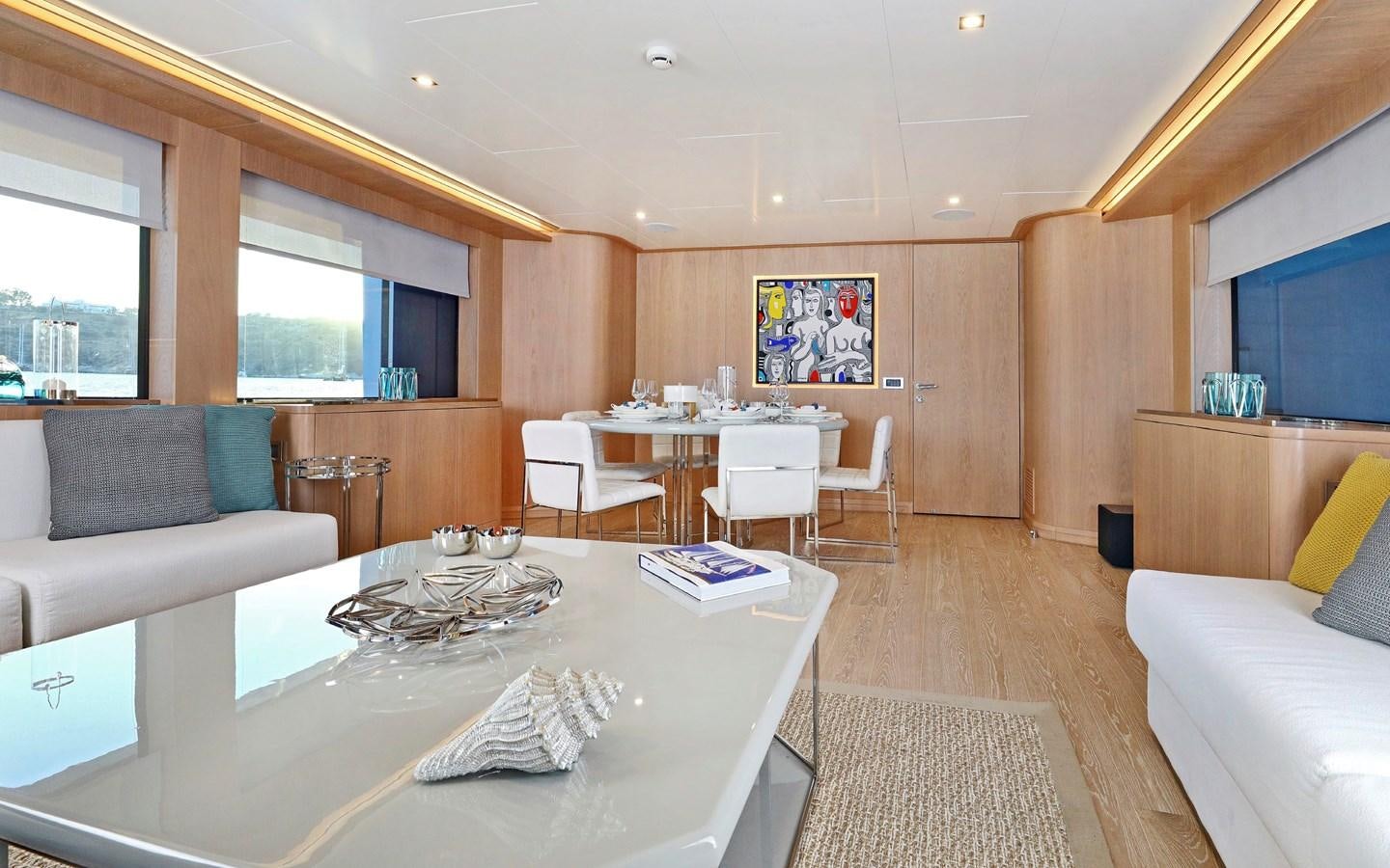 a large living room with a large table and chairs aboard AEGEAN EXPLORER 26M/02 Yacht for Sale