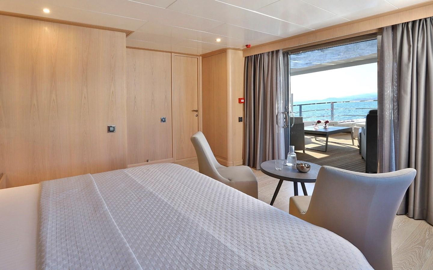 a room with a bed and a table and chairs aboard AEGEAN EXPLORER 26M/02 Yacht for Sale