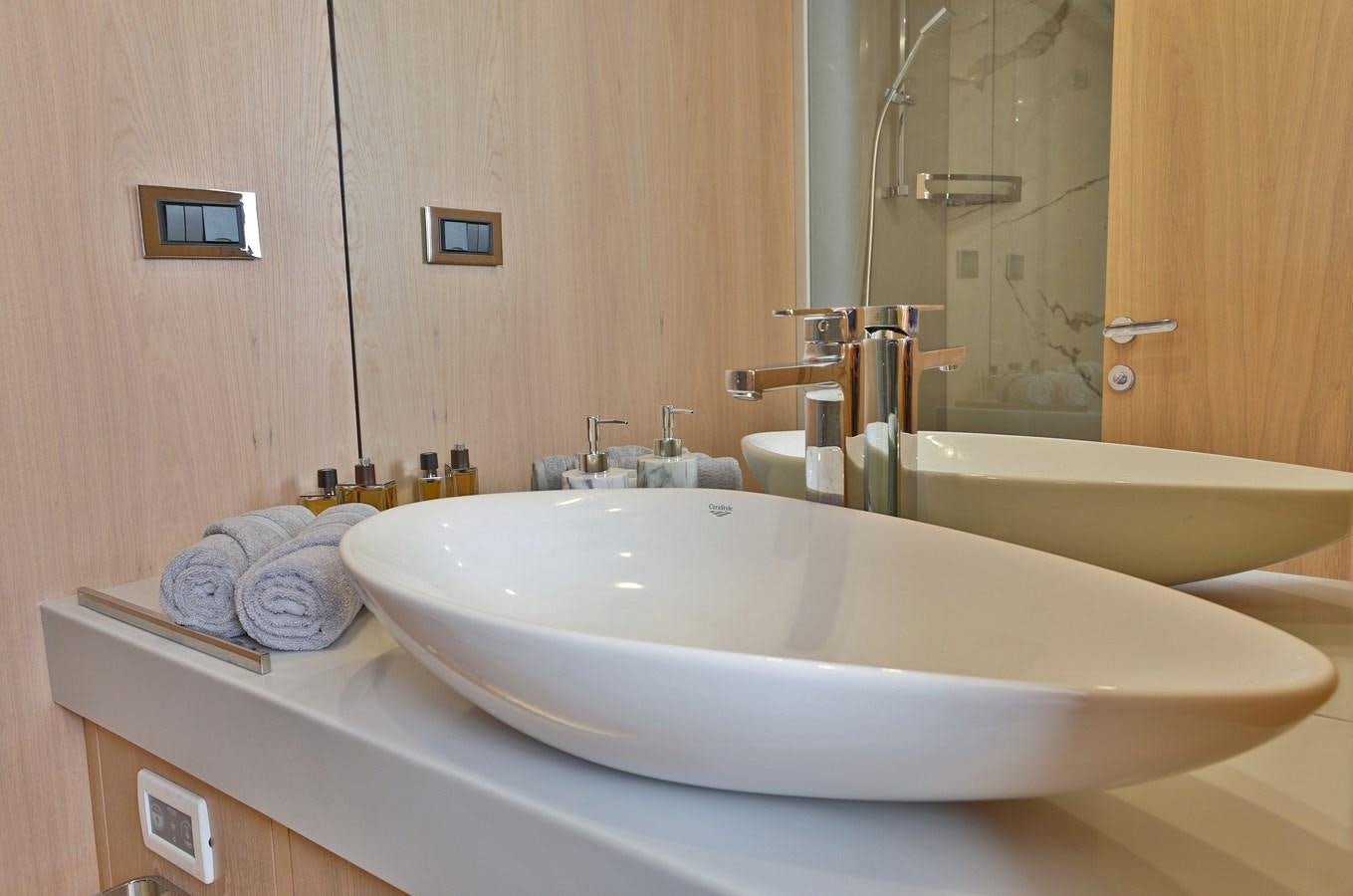 a bathroom with a bathtub and sink aboard AEGEAN EXPLORER 26M/02 Yacht for Sale