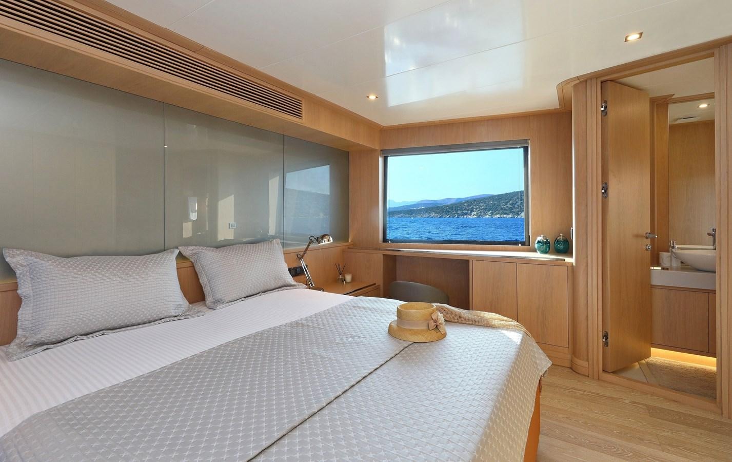 a bed with a white bed spread aboard AEGEAN EXPLORER 26M/02 Yacht for Sale