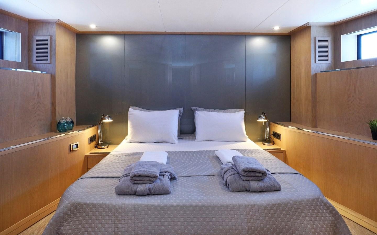 a bed with white pillows aboard AEGEAN EXPLORER 26M/02 Yacht for Sale