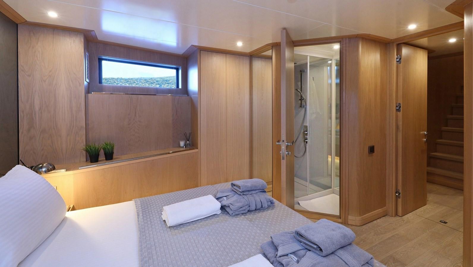 a hotel room with a bed and a closet aboard AEGEAN EXPLORER 26M/02 Yacht for Sale