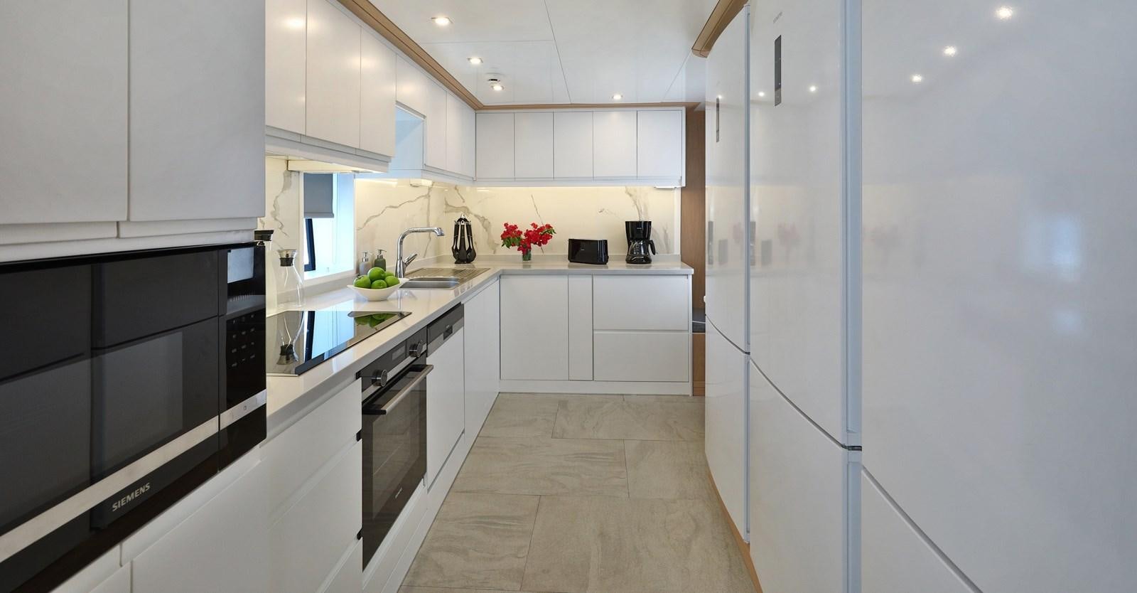 a kitchen with white cabinets aboard AEGEAN EXPLORER 26M/02 Yacht for Sale