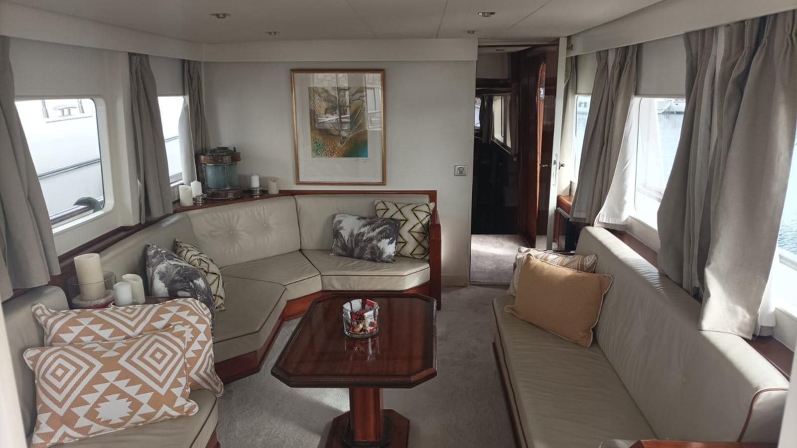 a living room with a couch and a coffee table aboard SEALORD Yacht for Sale