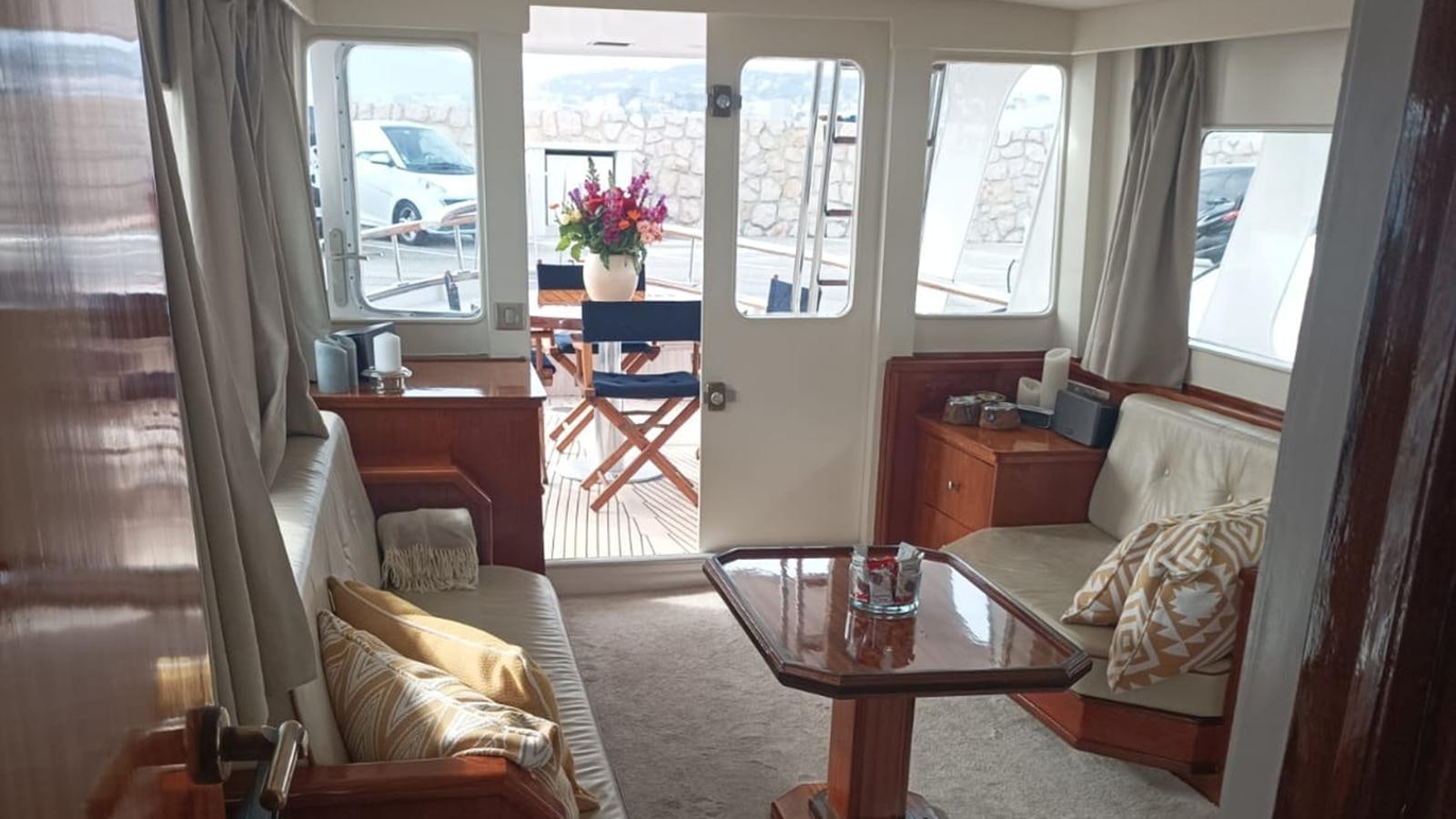a living room with a table and chairs aboard SEALORD Yacht for Sale