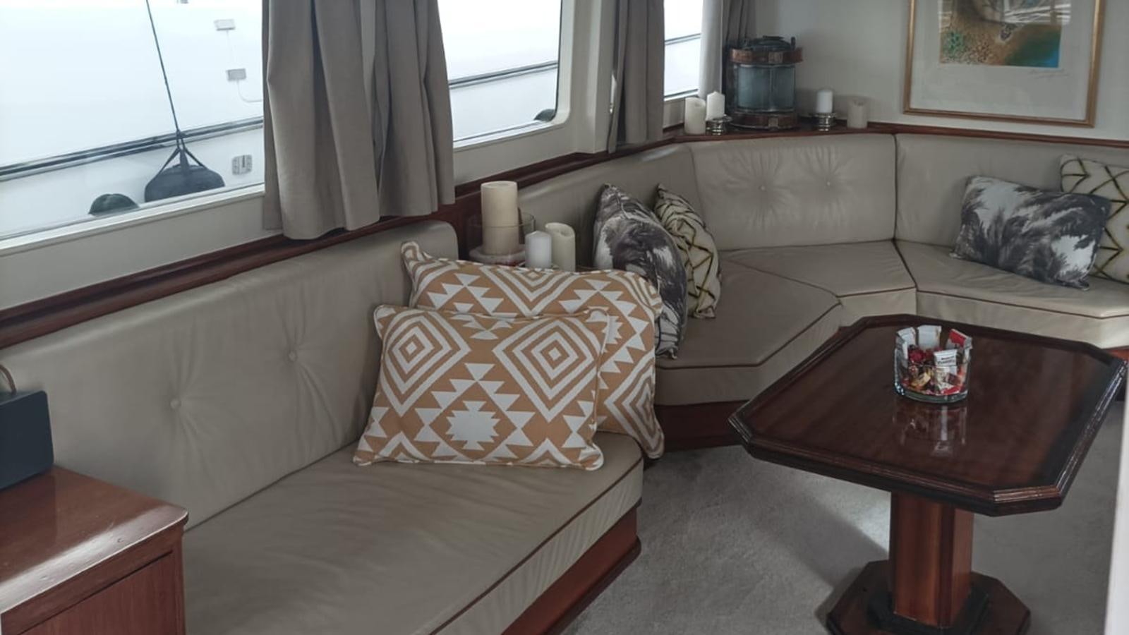 a living room with a couch and coffee table aboard SEALORD Yacht for Sale
