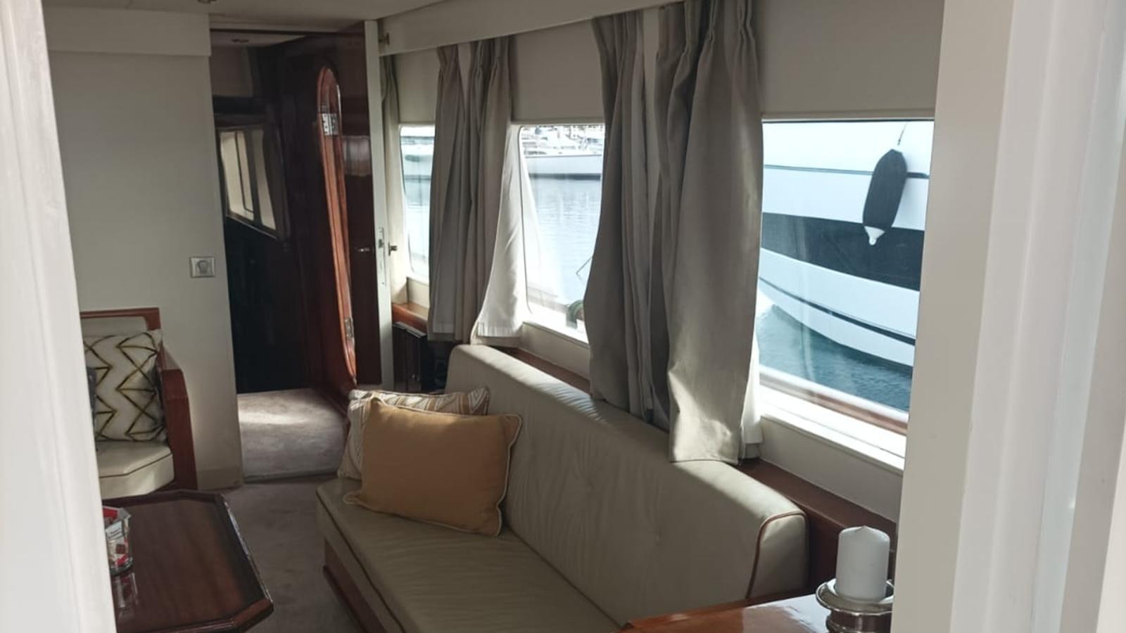 a living room with a couch and a window aboard SEALORD Yacht for Sale