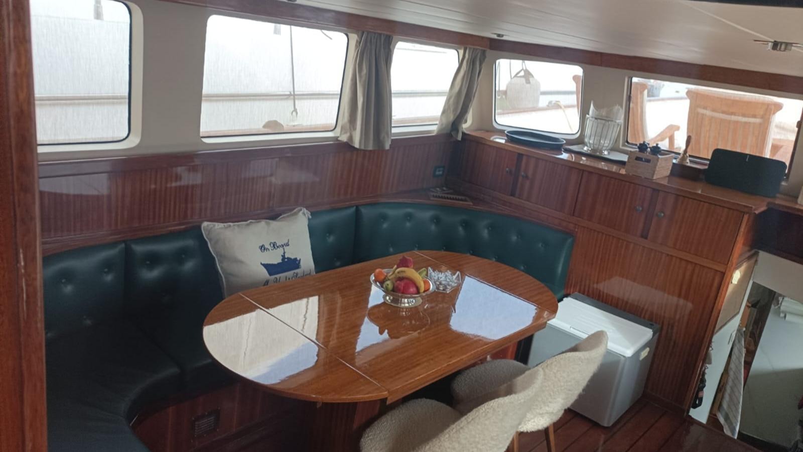 a table with chairs and a couch aboard SEALORD Yacht for Sale
