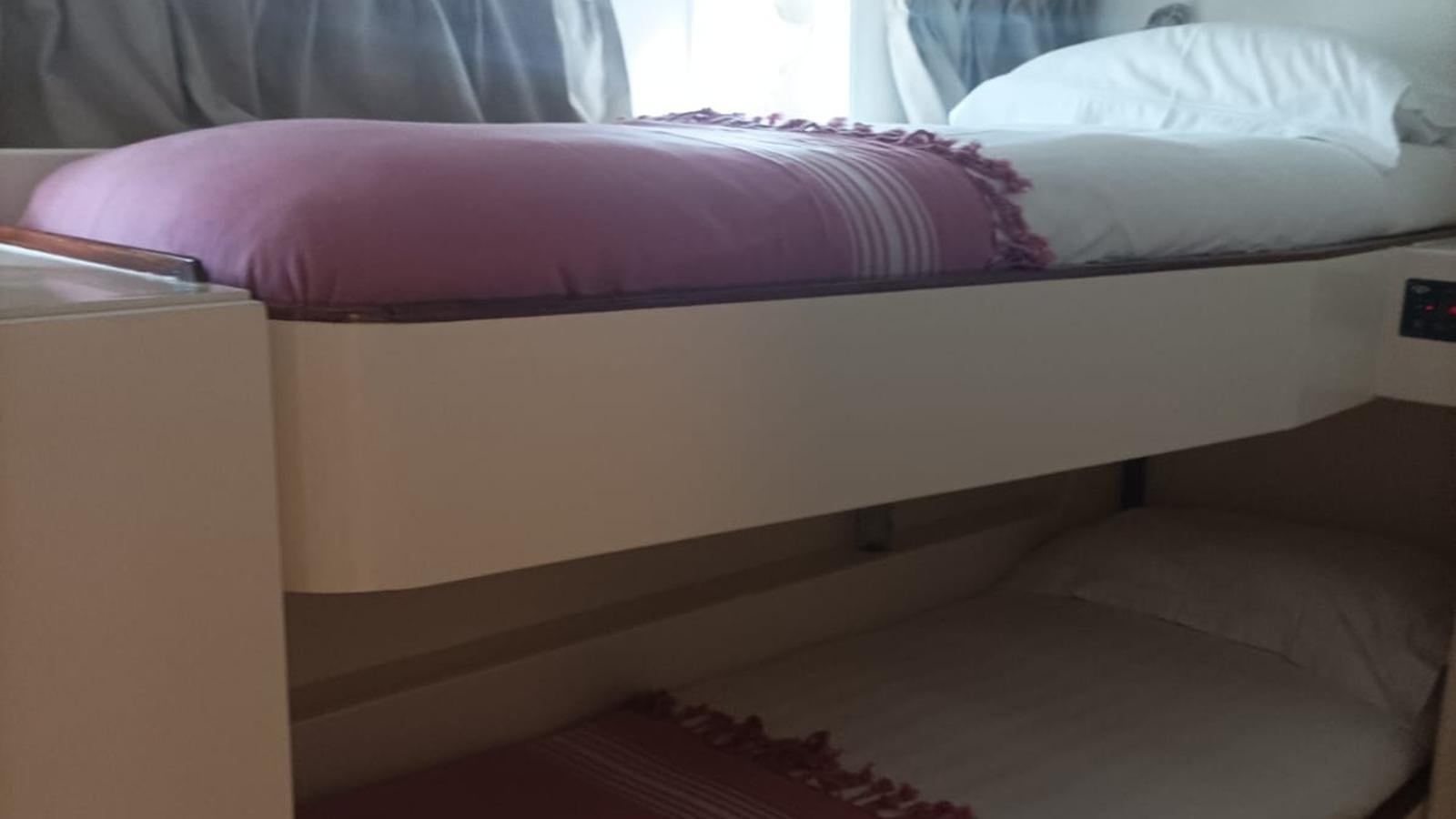 a bed with pink sheets aboard SEALORD Yacht for Sale