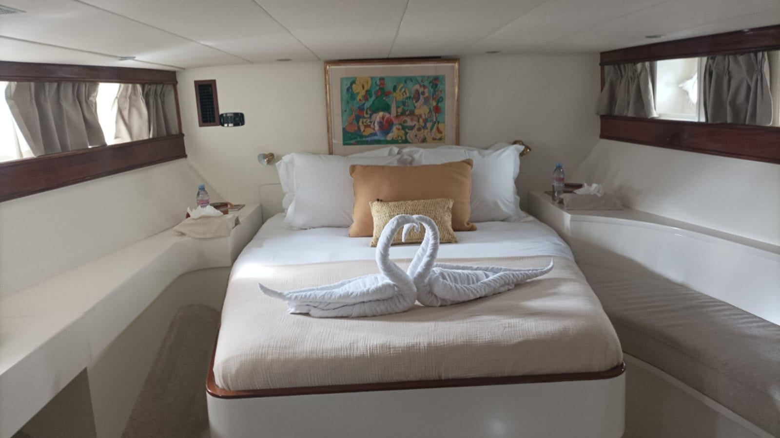 a bed with a white pillow and a white blanket on it aboard SEALORD Yacht for Sale