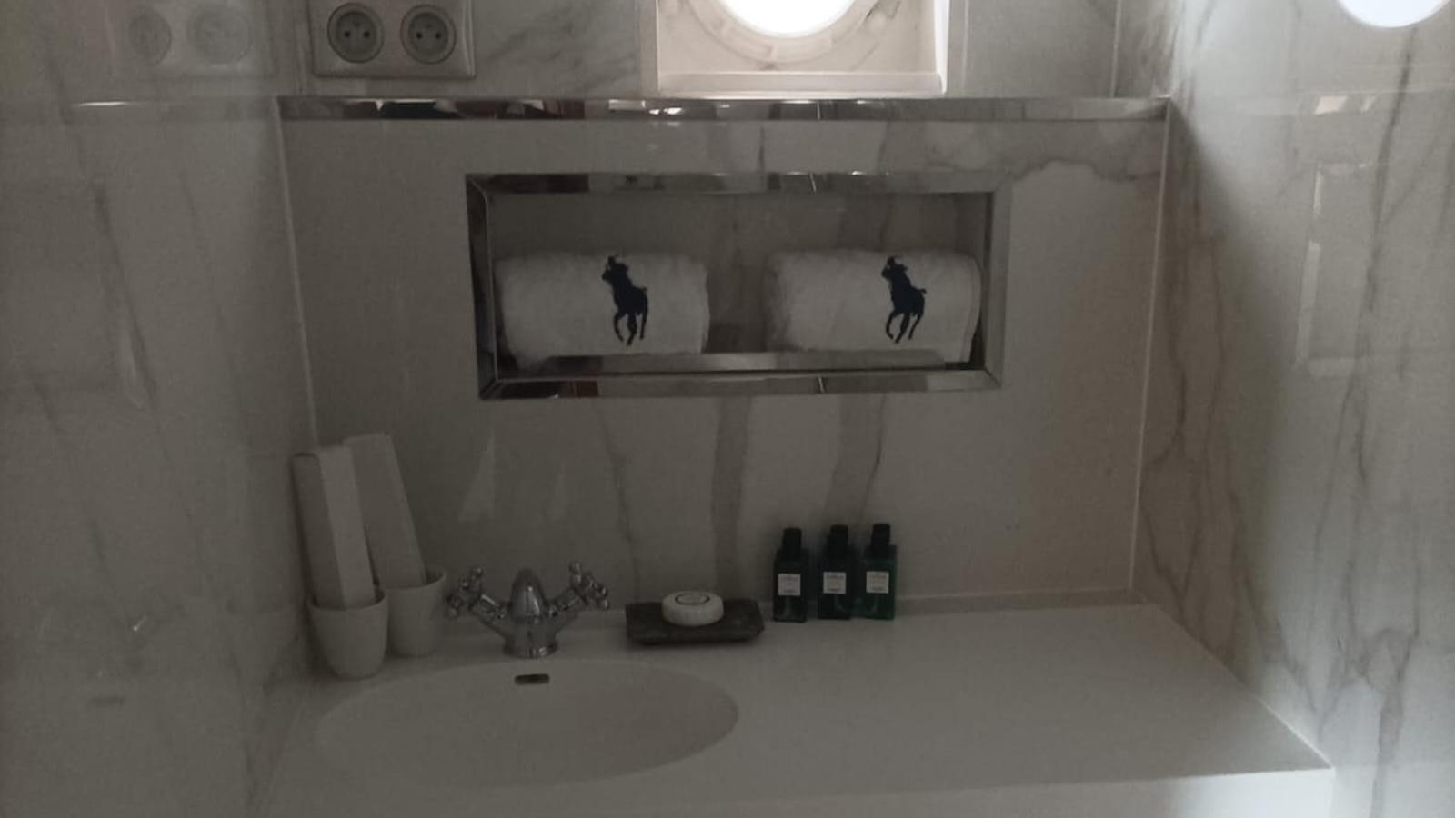 a bathroom with a sink and a mirror aboard SEALORD Yacht for Sale