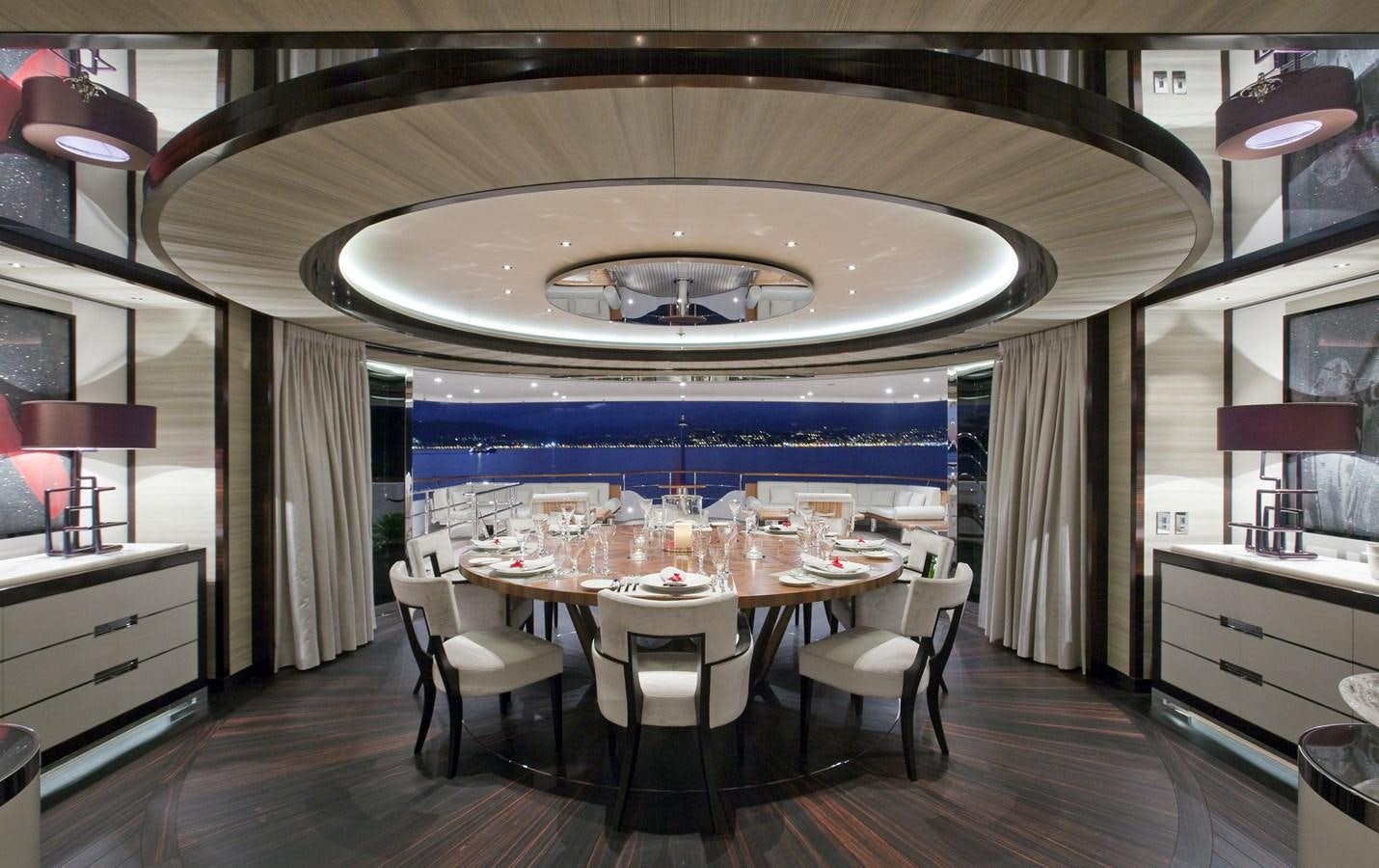 a dining room with a table and chairs aboard KAHALANI Yacht for Sale