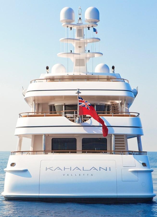 a large white boat with flags on it aboard KAHALANI Yacht for Sale