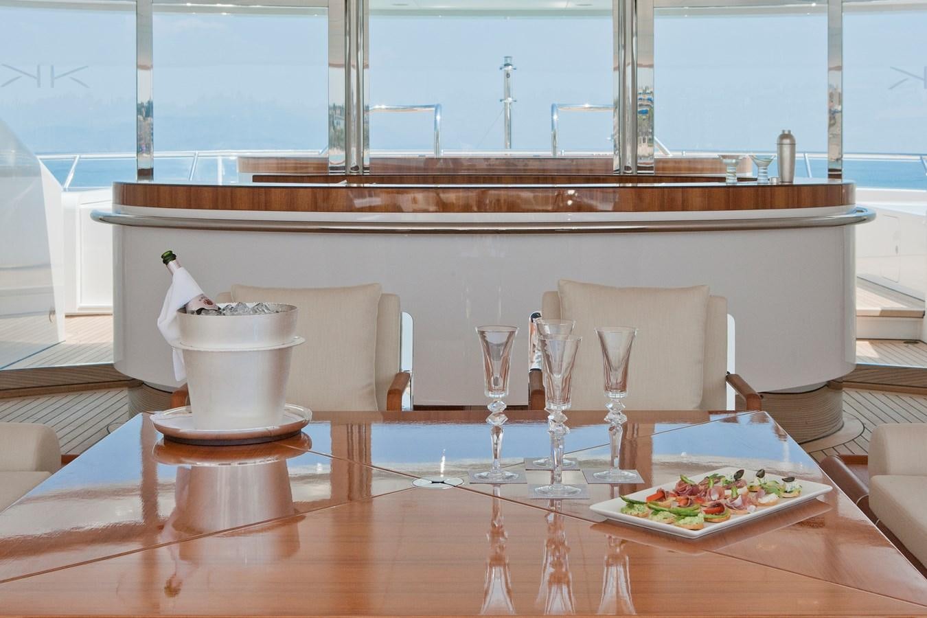 a table with food and glasses aboard KAHALANI Yacht for Sale